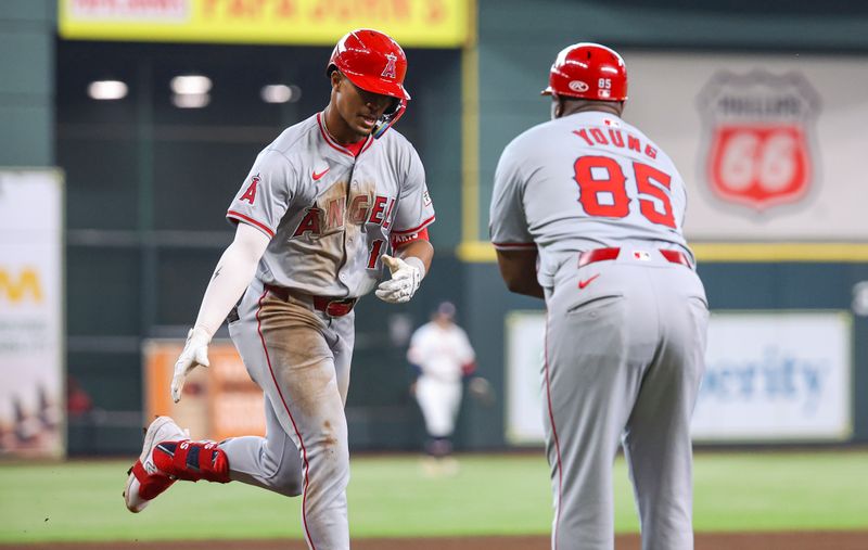 May 22, 2024; Houston, Texas, USA; Los Angeles Angels second baseman Kyren Paris (19) celebrates with third base coach Eric Young Sr. (85) after hitting a home run during the fifth inning against the Houston Astros at Minute Maid Park. Mandatory Credit: Troy Taormina-USA TODAY Sports