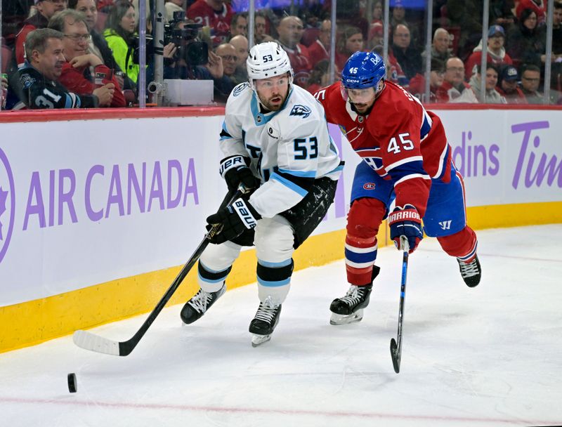 Nov 8, 2025; Montreal, Quebec, CAN; Utah Mammoth forward Michael Carcone (53) plays the puck and Montreal Canadiens defenseman Alexandre Carrier (45) defends during the second period at the Bell Centre. Mandatory Credit: Eric Bolte-Imagn Images
