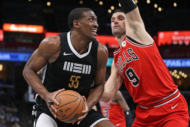 MEMPHIS, TENNESSEE - FEBRUARY 08: Trey Jemison #55 of the Memphis Grizzlies handles the ball against Nikola Vucevic #9 of the Chicago Bulls during the second half at FedExForum on February 08, 2024 in Memphis, Tennessee. NOTE TO USER: User expressly acknowledges and agrees that, by downloading and or using this photograph, User is consenting to the terms and conditions of the Getty Images License Agreement. (Photo by Justin Ford/Getty Images)