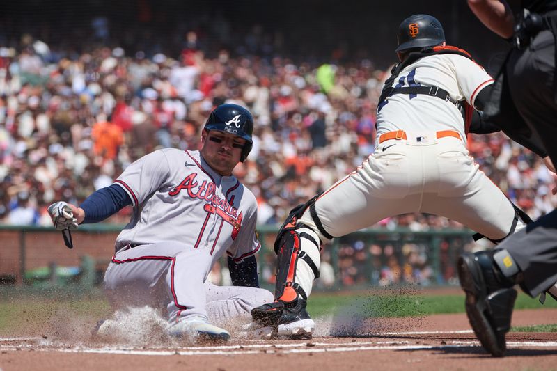 Aug 26, 2023; San Francisco, California, USA; Atlanta Braves infielder Austin Riley (27) slides safely into home against San Francisco Giants catcher Patrick Bailey (14) during the first inning at Oracle Park. Mandatory Credit: Robert Edwards-USA TODAY Sports