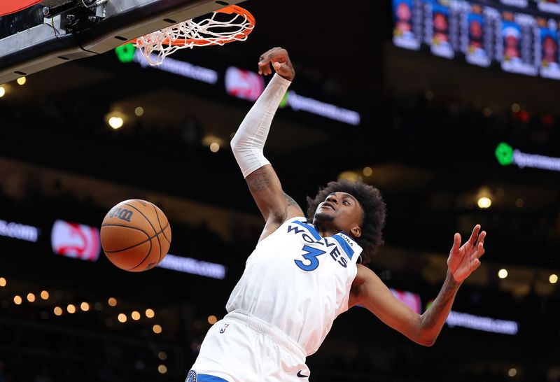 ATLANTA, GEORGIA - OCTOBER 30:  Jaden McDaniels #3 of the Minnesota Timberwolves dunks against the Atlanta Hawks during the first quarter at State Farm Arena on October 30, 2023 in Atlanta, Georgia.  NOTE TO USER: User expressly acknowledges and agrees that, by downloading and/or using this photograph, user is consenting to the terms and conditions of the Getty Images License Agreement.  (Photo by Kevin C. Cox/Getty Images)