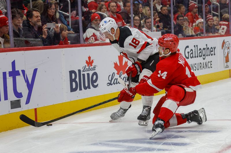 Nov 29, 2024; Detroit, Michigan, USA; Detroit Red Wings center Tyler Motte (14) fights for control of the puck with New Jersey Devils left wing Ondrej Palat (18) during the second period at Little Caesars Arena. Mandatory Credit: Brian Bradshaw Sevald-Imagn Images