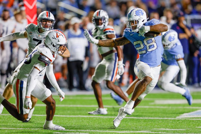 Oct 21, 2023; Chapel Hill, North Carolina, USA; North Carolina Tar Heels running back Omarion Hampton (28) runs the ball against the Virginia Cavaliers in the second half at Kenan Memorial Stadium. Mandatory Credit: Nell Redmond-USA TODAY Sports