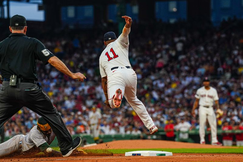 Jul 9, 2024; Boston, Massachusetts, USA; Oakland Athletics right fielder Lawrence Butler (4) steals third base  are against Boston Red Sox third baseman Rafael Devers (11) in the second inning at Fenway Park. Mandatory Credit: David Butler II-USA TODAY Sports