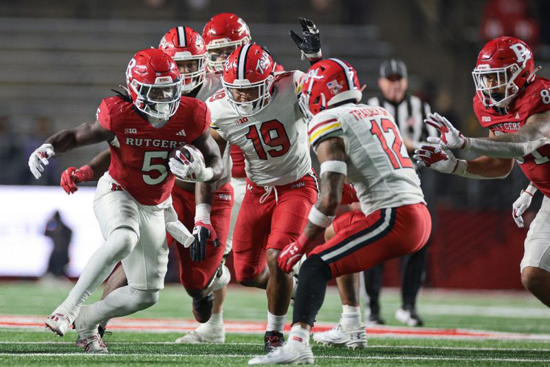 Nov 25, 2023; Piscataway, New Jersey, USA; Rutgers Scarlet Knights running back Kyle Monangai (5) carries the ball as Maryland Terrapins defensive lineman Donnell Brown (19) pursues during the second half at SHI Stadium. Mandatory Credit: Vincent Carchietta-USA TODAY Sports