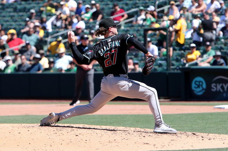Aug 3, 2025; West Sacramento, California, USA; Arizona Diamondbacks pitcher Andrew Saalfrank (27) throws a pitch against the Athletics during the seventh inning at Sutter Health Park. Mandatory Credit: Dennis Lee-Imagn Images