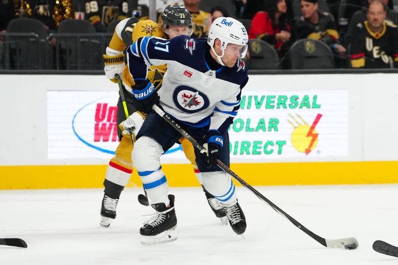 Nov 2, 2023; Las Vegas, Nevada, USA; Winnipeg Jets left wing Nikolaj Ehlers (27) shoots against the Vegas Golden Knights during the second period at T-Mobile Arena. Mandatory Credit: Stephen R. Sylvanie-USA TODAY Sports