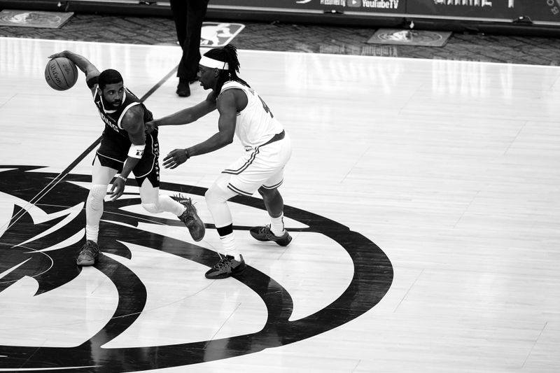 DALLAS, TX - JUNE 12: Kyrie Irving #11 of the Dallas Mavericks handles the ball during the game against the Boston Celtics during Game Three of the 2024 NBA Finals on June 12, 2024 at the American Airlines Center in Dallas, Texas. NOTE TO USER: User expressly acknowledges and agrees that, by downloading and or using this photograph, User is consenting to the terms and conditions of the Getty Images License Agreement. Mandatory Copyright Notice: Copyright 2024 NBAE (Photo by Glenn James/NBAE via Getty Images)
