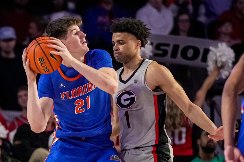 Feb 17, 2024; Athens, Georgia, USA; Florida Gators forward Alex Condon (21) is defended by Georgia Bulldogs guard Jabri Abdur-Rahim (1) during the first half at Stegeman Coliseum. Mandatory Credit: Dale Zanine-USA TODAY Sports