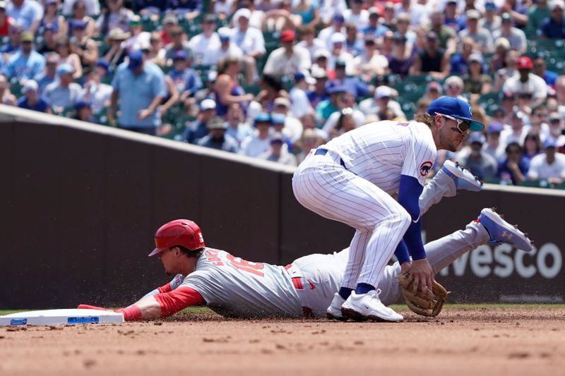 Jun 16, 2024; Chicago, Illinois, USA; St. Louis Cardinals second baseman steals second base as Chicago Cubs second baseman Nico Hoerner (2) takes a throw during the second inning at Wrigley Field. Mandatory Credit: David Banks-USA TODAY Sports