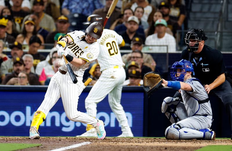 Oct 8, 2024; San Diego, California, USA; San Diego Padres first baseman Jake Cronenworth (9) singles in the fourth inning against the Los Angeles Dodgers during game three of the NLDS for the 2024 MLB Playoffs at Petco Park. Mandatory Credit: David Frerker-Imagn Images