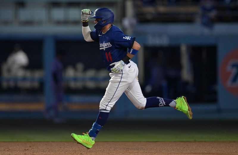 Sep 18, 2023; Los Angeles, California, USA;  Los Angeles Dodgers shortstop Miguel Rojas (11) rounds the bases on a solo home run in the seventh inning against the Detroit Tigers at Dodger Stadium. Mandatory Credit: Jayne Kamin-Oncea-USA TODAY Sports