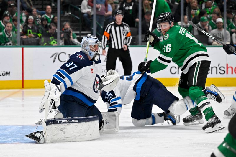 Feb 29, 2024; Dallas, Texas, USA; Dallas Stars center Joe Pavelski (16) checks Winnipeg Jets center Mark Scheifele (55) as goaltender Connor Hellebuyck (37) looks for the puck in the Jets zone during the second period at the American Airlines Center. Mandatory Credit: Jerome Miron-USA TODAY Sports