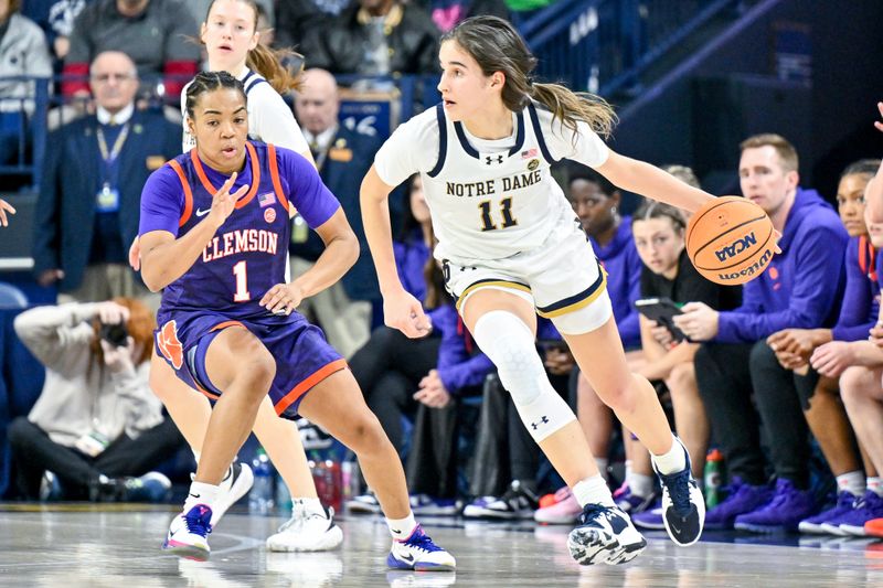 Feb 22, 2024; South Bend, Indiana, USA; Notre Dame Fighting Irish guard Sonia Citron (11) dribbles as Clemson Tigers guard Dayshanette Harris (1) defends in the first half at the Purcell Pavilion. Mandatory Credit: Matt Cashore-USA TODAY Sports