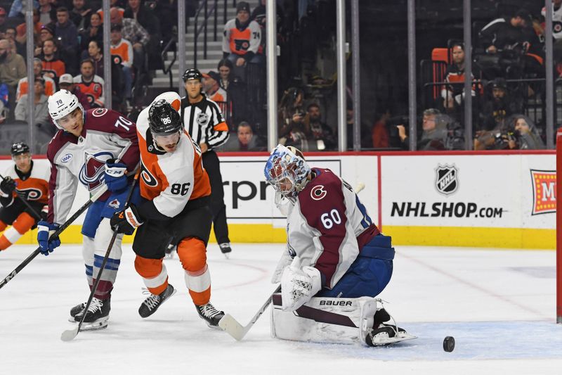 Nov 18, 2024; Philadelphia, Pennsylvania, USA; Colorado Avalanche goaltender Justus Annunen (60) makes a save against Philadelphia Flyers left wing Joel Farabee (86) during the first period at Wells Fargo Center. Mandatory Credit: Eric Hartline-Imagn Images