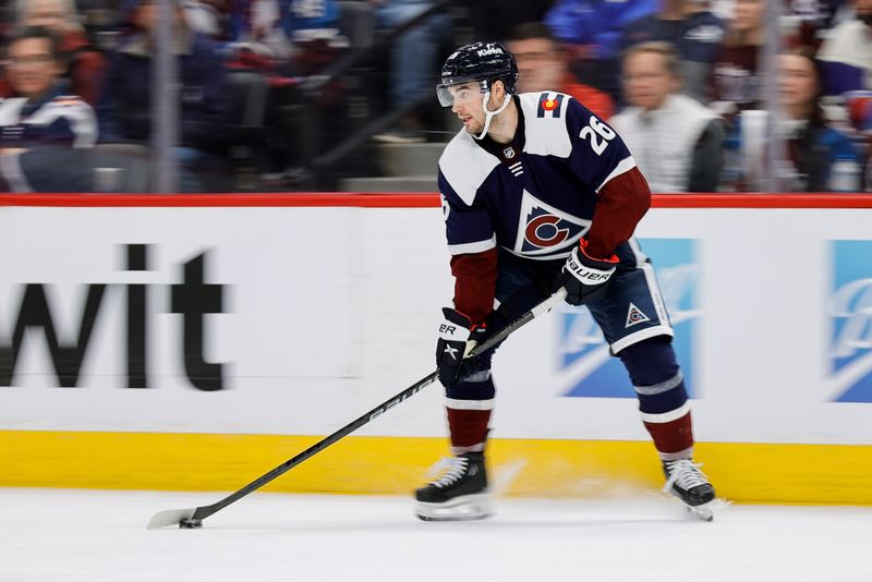 Mar 8, 2024; Denver, Colorado, USA; Colorado Avalanche defenseman Sean Walker (26) controls the puck in the third period against the Minnesota Wild at Ball Arena. Mandatory Credit: Isaiah J. Downing-USA TODAY Sports