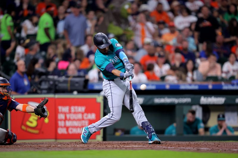 May 4, 2024; Houston, Texas, USA; Seattle Mariners second baseman Jorge Polanco (7) hits a double to right field against the Houston Astros during the fourth inning at Minute Maid Park. Mandatory Credit: Erik Williams-USA TODAY Sports