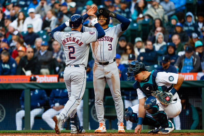 May 28, 2024; Seattle, Washington, USA; Houston Astros third baseman Alex Bregman (2) reacts with shortstop Jeremy Pena (3) after hitting a two-run home run against the Seattle Mariners during the fourth inning at T-Mobile Park. Mandatory Credit: Joe Nicholson-USA TODAY Sports