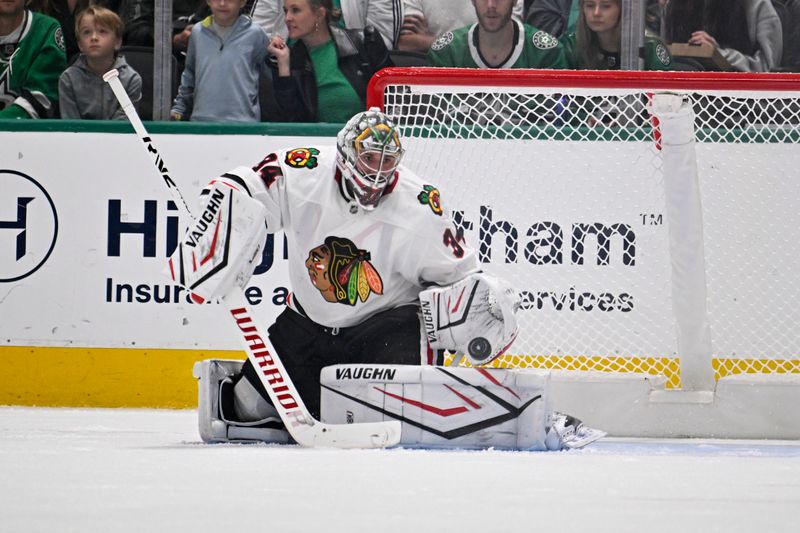 Oct 26, 2024; Dallas, Texas, USA; Chicago Blackhawks goaltender Petr Mrazek (34) makes a save on a Dallas Stars shot during the first period at the American Airlines Center. Mandatory Credit: Jerome Miron-Imagn Images