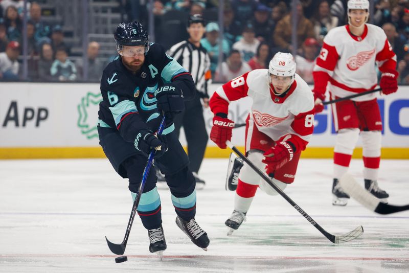 Feb 19, 2024; Seattle, Washington, USA; Seattle Kraken defenseman Adam Larsson (6) passes the puck away from Detroit Red Wings right wing Patrick Kane (88) during the first period at Climate Pledge Arena. Mandatory Credit: Joe Nicholson-USA TODAY Sports