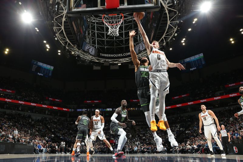 MINNEAPOLIS, MN -  NOVEMBER 1: Christian Braun #0 of the Denver Nuggets drives to the basket during the game against the Minnesota Timberwolves  on November 1, 2024 at Target Center in Minneapolis, Minnesota. NOTE TO USER: User expressly acknowledges and agrees that, by downloading and or using this Photograph, user is consenting to the terms and conditions of the Getty Images License Agreement. Mandatory Copyright Notice: Copyright 2024 NBAE (Photo by David Sherman/NBAE via Getty Images)