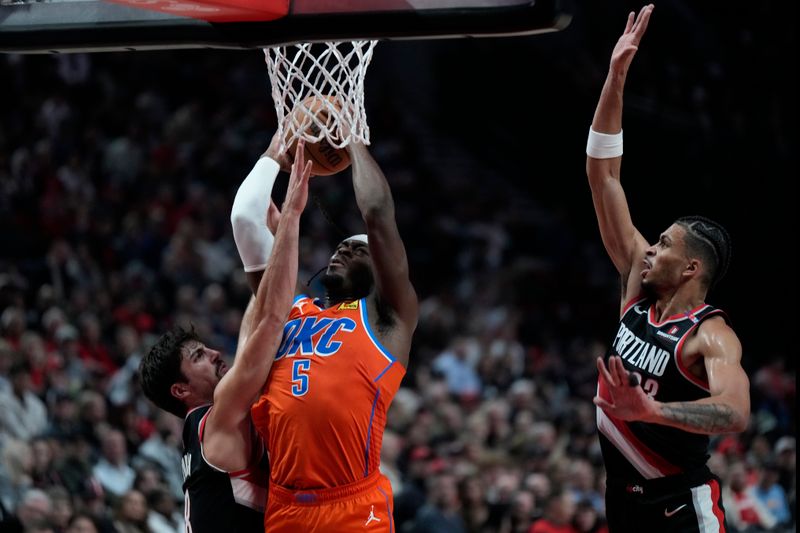 PORTLAND, OREGON - NOVEMBER 01: Luguentz Dort #5 of the Oklahoma City Thunder shoots the ball against Deni Avdija #8 of the Portland Trail Blazers during the second half at Moda Center on November 01, 2024 in Portland, Oregon. NOTE TO USER: User expressly acknowledges and agrees that, by downloading and or using this photograph, User is consenting to the terms and conditions of the Getty Images License Agreement. (Photo by Soobum Im/Getty Images)