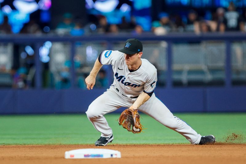 Jun 4, 2023; Miami, Florida, USA; Miami Marlins shortstop Joey Wendle (18) catches a ground ball during the seventh inning against the Oakland Athletics at loanDepot Park. Mandatory Credit: Sam Navarro-USA TODAY Sports