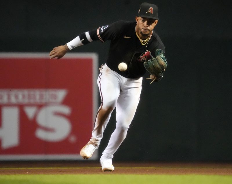 Jun 17, 2023; Phoenix, Arizona, USA; Arizona Diamondbacks second baseman Ketel Marte (4) fields a ground ball against the Cleveland Guardians at Chase Field. Mandatory Credit: Joe Rondone-USA TODAY Sports