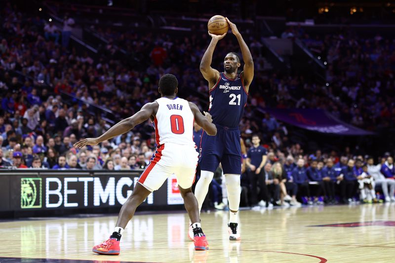 PHILADELPHIA, PENNSYLVANIA - APRIL 09: Joel Embiid #21 of the Philadelphia 76ers shoots over Jalen Duren #0 of the Detroit Pistons during the fourth quarter at the Wells Fargo Center on April 09, 2024 in Philadelphia, Pennsylvania. (Photo by Tim Nwachukwu/Getty Images)