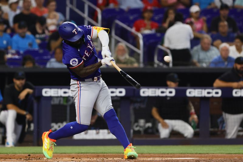 Jun 2, 2024; Miami, Florida, USA; Texas Rangers right fielder Adolis Garcia (53) hits an RBI single against the Miami Marlins during the first inning at loanDepot Park. Mandatory Credit: Sam Navarro-USA TODAY Sports