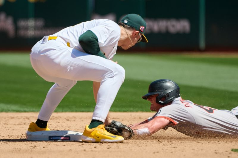 Aug 18, 2024; Oakland, California, USA; Oakland Athletics infielder Zack Gelof (20) tags out San Francisco Giants infielder Tyler Fitzgerald (49) at second base during the sixth inning at Oakland-Alameda County Coliseum. Mandatory Credit: Robert Edwards-USA TODAY Sports