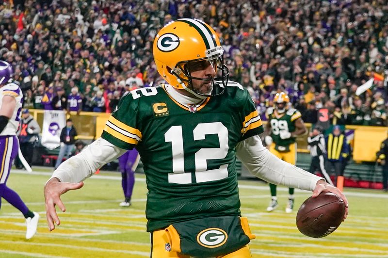 Green Bay Packers' Aaron Rodgers reacts after running for a touchdown during an NFL football game against the Minnesota Vikings Sunday, Jan. 1, 2023, in Green Bay, Wis. (AP Photo/Morry Gash)