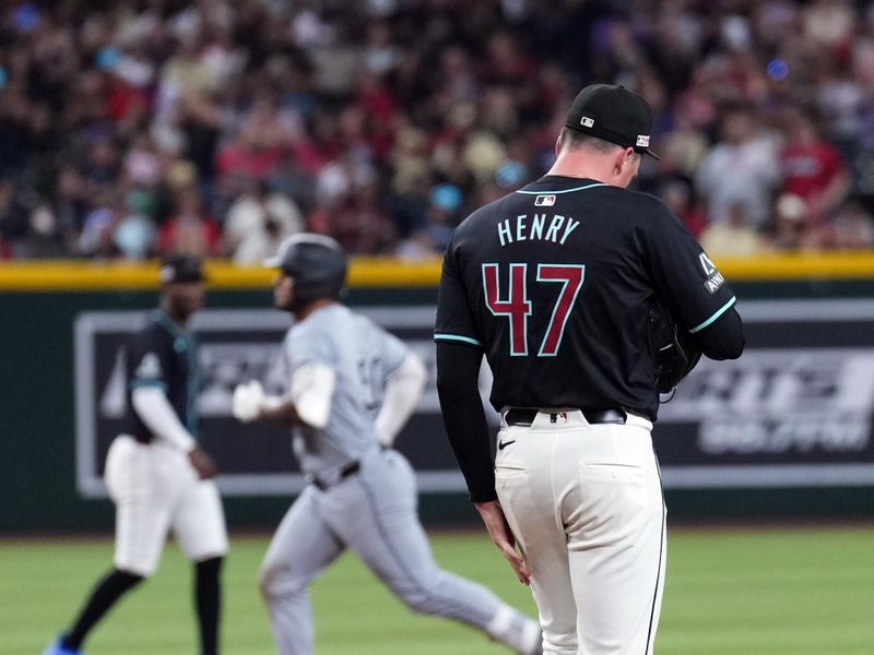 Jun 15, 2024; Phoenix, Arizona, USA; Arizona Diamondbacks pitcher Tommy Henry (47) reacts after giving up a three run home run to Chicago White Sox third base Lenyn Sosa (50) during the seventh inning at Chase Field. Mandatory Credit: Joe Camporeale-USA TODAY Sports