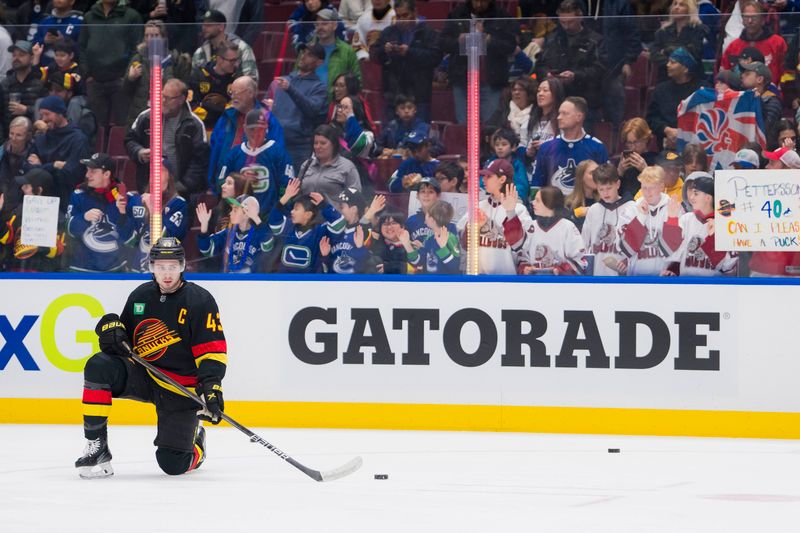 Feb 15, 2024; Vancouver, British Columbia, CAN; Vancouver Canucks defenseman Quinn Hughes (43) stretches during warm up prior to a game against the Detroit Red Wings at Rogers Arena.  Mandatory Credit: Bob Frid-USA TODAY Sports