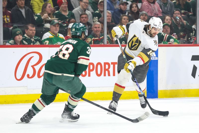 Apr 3, 2023; Saint Paul, Minnesota, USA; Vegas Golden Knights defenseman Nicolas Hague (14) shoots while Minnesota Wild right wing Ryan Hartman (38) defends during the first period at Xcel Energy Center. Mandatory Credit: Matt Krohn-USA TODAY Sports