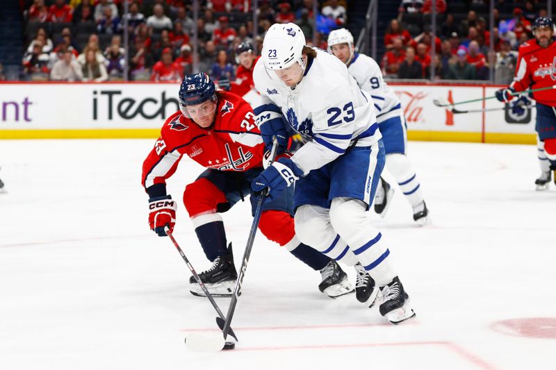 Mar 20, 2024; Washington, District of Columbia, USA; Toronto Maple Leafs left wing Matthew Knies (23) battles for the puck with Washington Capitals center Michael Sgarbossa (23) during the first period at Capital One Arena. Mandatory Credit: Amber Searls-USA TODAY Sports