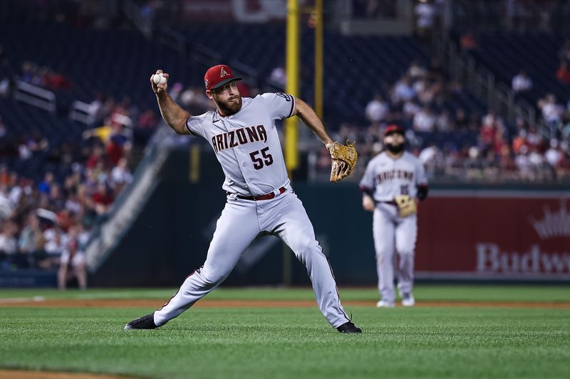 Jun 7, 2023; Washington, District of Columbia, USA; Arizona Diamondbacks relief pitcher Austin Adams (55) fields a hit to retire Washington Nationals center fielder Alex Call (17) during the seventh inning at Nationals Park. Mandatory Credit: Scott Taetsch-USA TODAY Sports