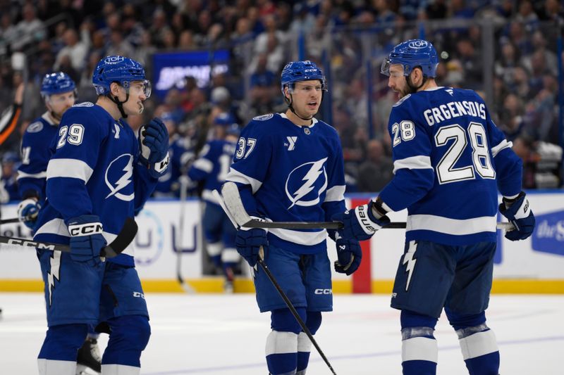 Mar 26, 2026; Tampa, Florida, USA; Tampa Bay Lightning Yanni Gourde (37) and Zemgus Girgensons (28) react during the first period against Seattle Kraken at Benchmark International Arena. Mandatory Credit: Pablo Robles-Imagn Images