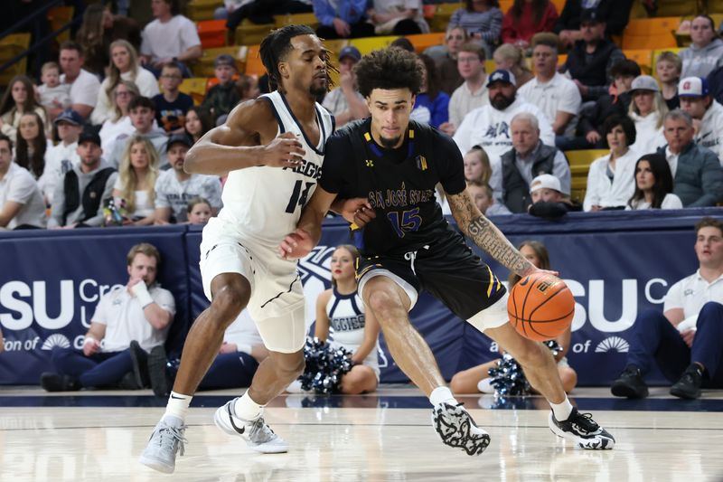 Jan 30, 2024; Logan, Utah, USA; San Jose State Spartans forward Trey Anderson (15) dribbles against Utah State Aggies guard Josh Uduje (14) during the first half at Dee Glen Smith Spectrum. Mandatory Credit: Rob Gray-USA TODAY Sports