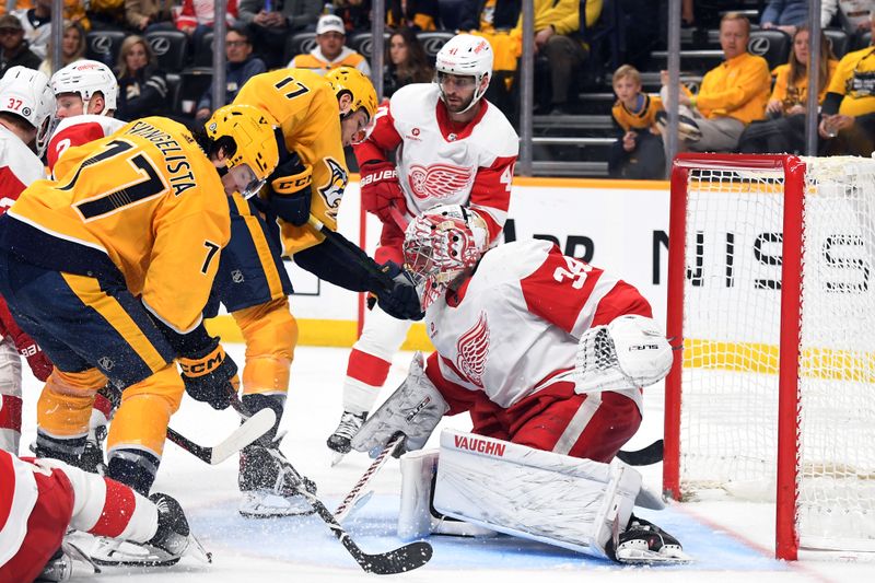 Mar 23, 2024; Nashville, Tennessee, USA; Detroit Red Wings goaltender Alex Lyon (34) makes a save on a play by Nashville Predators center Mark Jankowski (17) and right wing Luke Evangelista (77) during the third period at Bridgestone Arena. Mandatory Credit: Christopher Hanewinckel-USA TODAY Sports