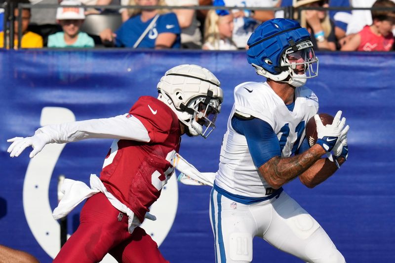 Indianapolis Colts wide receiver Michael Pittman Jr. (11) makes a catch against Arizona Cardinals' Delonte Hood during a joint NFL football practice, Wednesday, Aug. 14, 2024, in Westfield, Ind. (AP Photo/Darron Cummings)