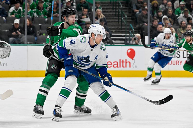 Dec 21, 2023; Dallas, Texas, USA; Vancouver Canucks center Elias Pettersson (40) battles for position in front of Dallas Stars defenseman Esa Lindell (23) during the first period at the American Airlines Center. Mandatory Credit: Jerome Miron-USA TODAY Sports