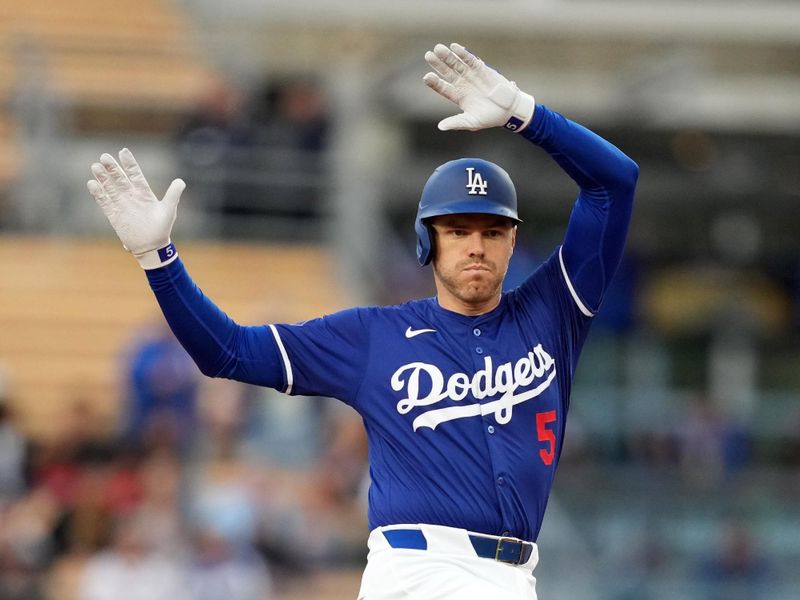 Mar 25, 2024; Los Angeles, California, USA; Los Angeles Dodgers first baseman Freddie Freeman (5) gestures after hitting a double in the first inning against the Los Angeles Angels at Dodger Stadium. Mandatory Credit: Kirby Lee-USA TODAY Sports