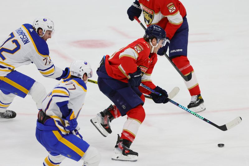 Apr 13, 2024; Sunrise, Florida, USA; Florida Panthers left wing Matthew Tkachuk (19) moves the puck past Buffalo Sabres center Tage Thompson (72) during the third period at Amerant Bank Arena. Mandatory Credit: Sam Navarro-USA TODAY Sports