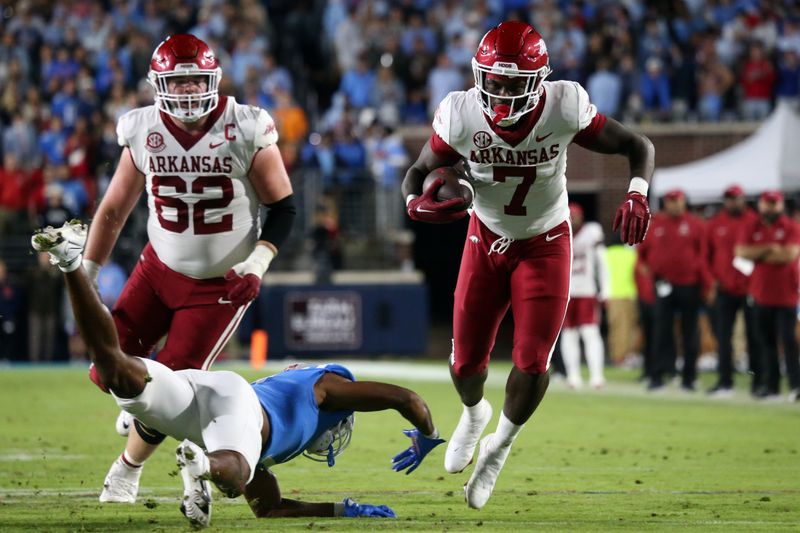 Oct 7, 2023; Oxford, Mississippi, USA; Arkansas Razorbacks running back Rashod Dubinion (7) avoids the tackle by Mississippi Rebels defensive back Deantre Prince (7) during the second half at Vaught-Hemingway Stadium. Mandatory Credit: Petre Thomas-USA TODAY Sports