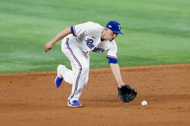 Oct 10, 2023; Arlington, Texas, USA; Texas Rangers shortstop Corey Seager (5) fields a ground ball in the sixth inning against the Baltimore Orioles during game three of the ALDS for the 2023 MLB playoffs at Globe Life Field. Mandatory Credit: Andrew Dieb-USA TODAY Sports