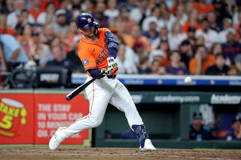 May 23, 2025; Houston, Texas, USA; Houston Astros first baseman Christian Walker (8) hits an RBI sacrifice fly against the Seattle Mariners during the fifth inning at Daikin Park. Mandatory Credit: Erik Williams-Imagn Images