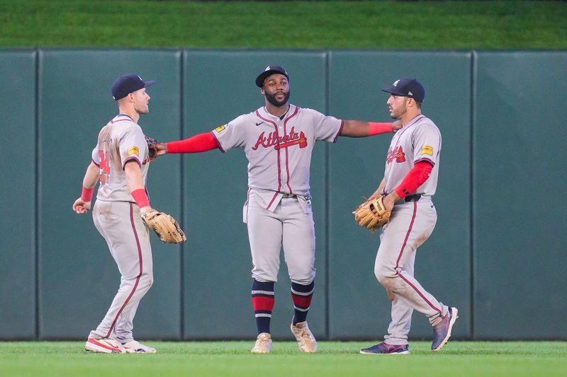 Aug 27, 2024; Minneapolis, Minnesota, USA; Atlanta Braves outfielder Jarred Kelenic (24), outfielder Michael Harris II (23) and outfielder Ramón Laureano (18) celebrate after the game against the Minnesota Twins at Target Field. Mandatory Credit: Brad Rempel-USA TODAY Sports