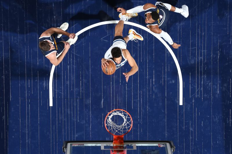 MINNEAPOLIS, MN -  OCTOBER 17: Jesse Edwards #14 of the Minnesota Timberwolves dunks the ball during the game against the Denver Nuggets during the 2024 NBA Preseason on October 17, 2024 at Target Center in Minneapolis, Minnesota. NOTE TO USER: User expressly acknowledges and agrees that, by downloading and or using this Photograph, user is consenting to the terms and conditions of the Getty Images License Agreement. Mandatory Copyright Notice: Copyright 2024 NBAE (Photo by David Sherman/NBAE via Getty Images)