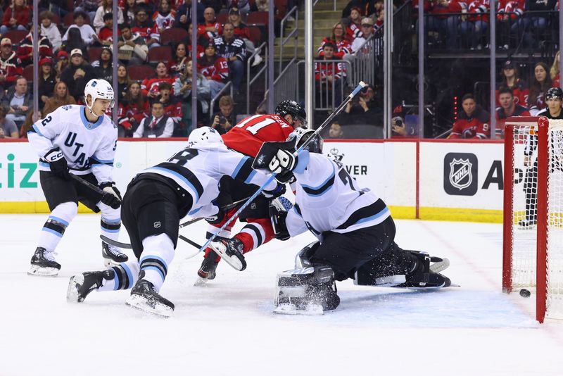 Oct 14, 2024; Newark, New Jersey, USA; New Jersey Devils right wing Stefan Noesen (11) scores a goal on Utah Hockey Club goaltender Karel Vejmelka (70) during the second period at Prudential Center. Mandatory Credit: Ed Mulholland-Imagn Images